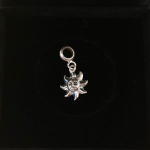 Silver sun charm
